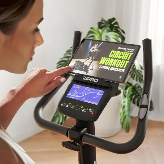 RAVE Vélo d'Appartement - 32 Niveaux de Résistance, Capteur de Fréquence Cardiaque, 11 Programmes d'Entraînement, Siège et Guidon Réglables, Connectivité Bluetooth, Idéal pour Cardio et Fitness